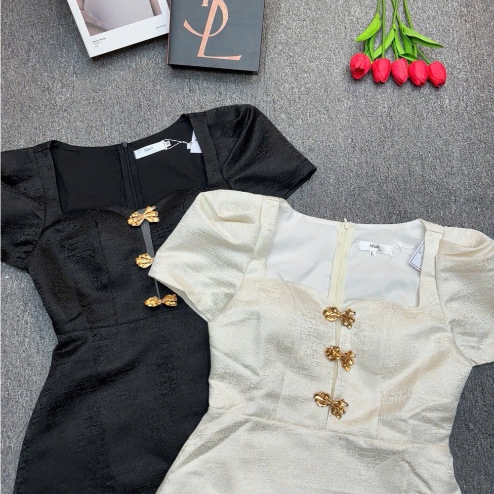 Elegant Black and Cream Dresses with Gold Accents